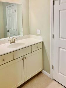 Bathroom vanity with white cabinets at 32 Cottonwood Drive