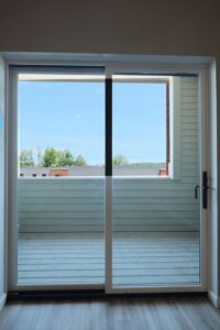 Sliding glass door and view of porch at Cottonwood Crossing