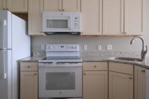 Cottonwood Crossing kitchen with bisque cabinets and white appliances